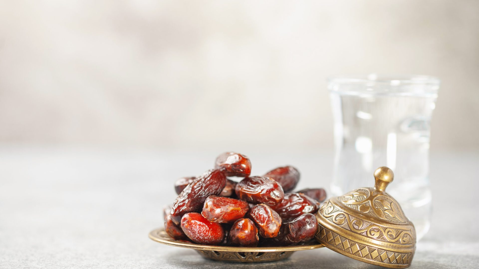 A,Glass,Of,Water,And,Dry,Dates,On,Saucer,Ready